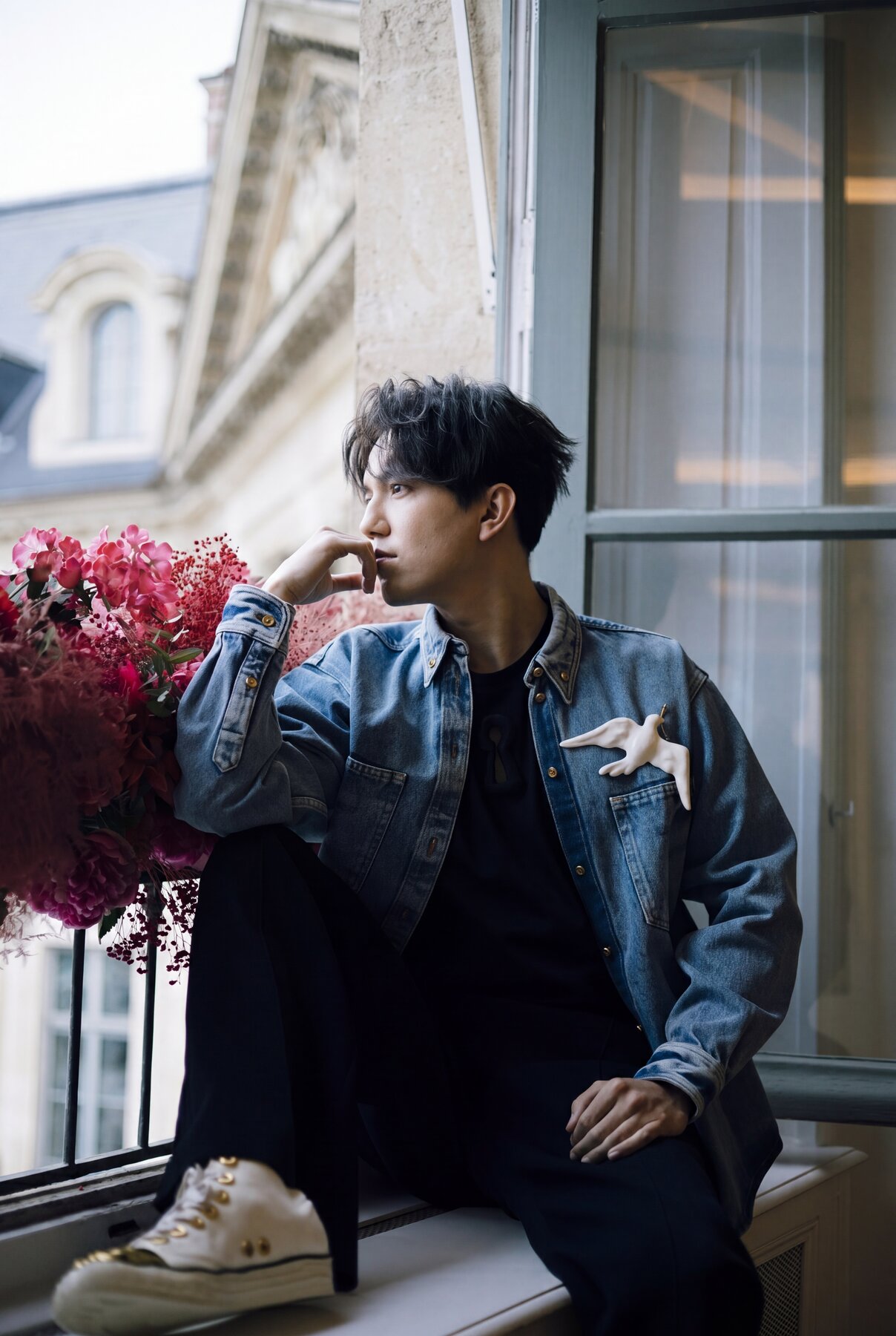 Dimash in denim with a dove pin, contemplative profile