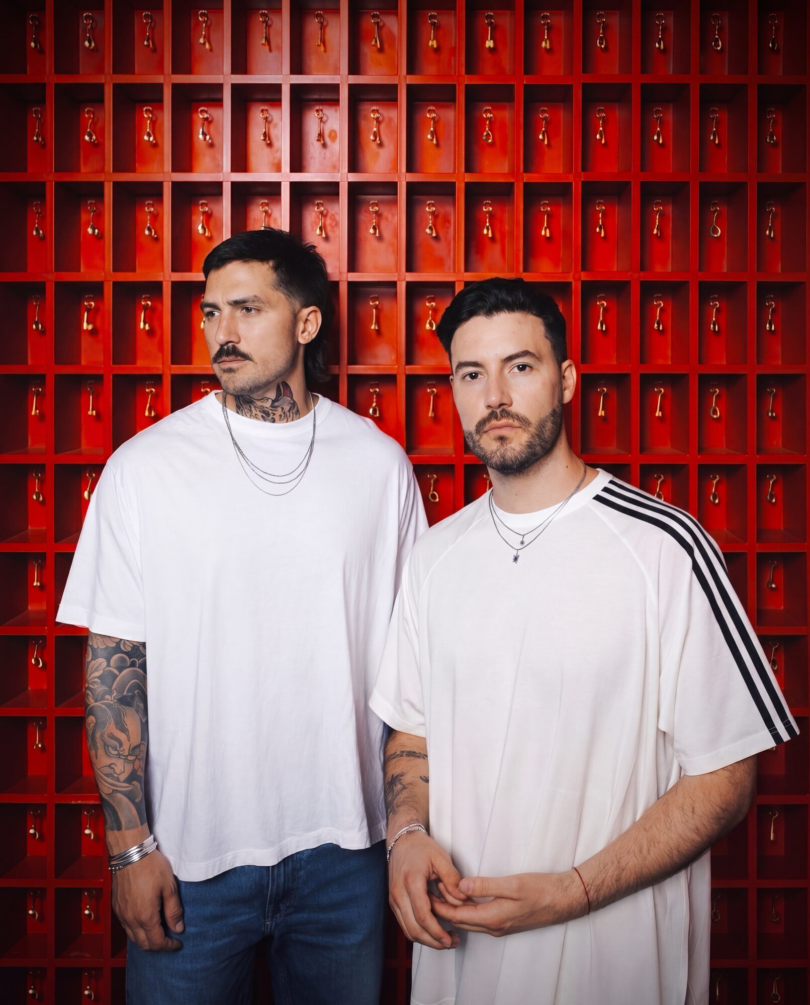 Tom & Collins editorial portrait — red key wall