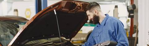 Mechanic working under the hood of a car